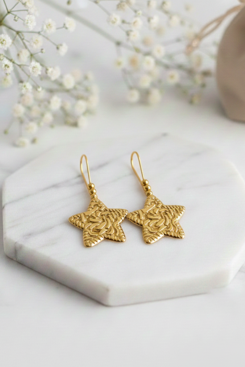 Pendientes acero estrella mediano labrado